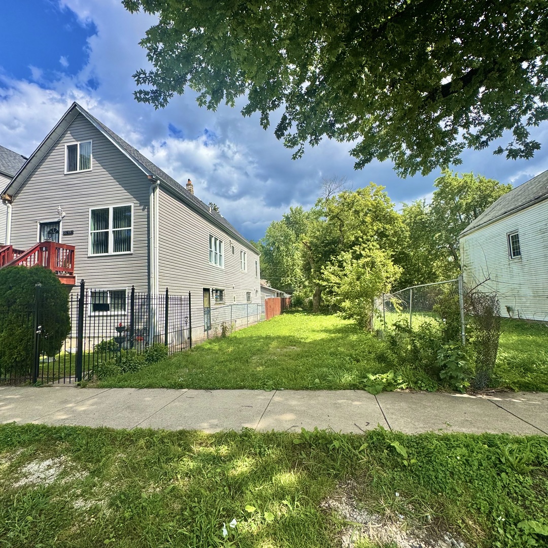 5217 South Wood Street Chicago, IL 60609 - Photo 1 of 2 a front view of a house with a yard and trees