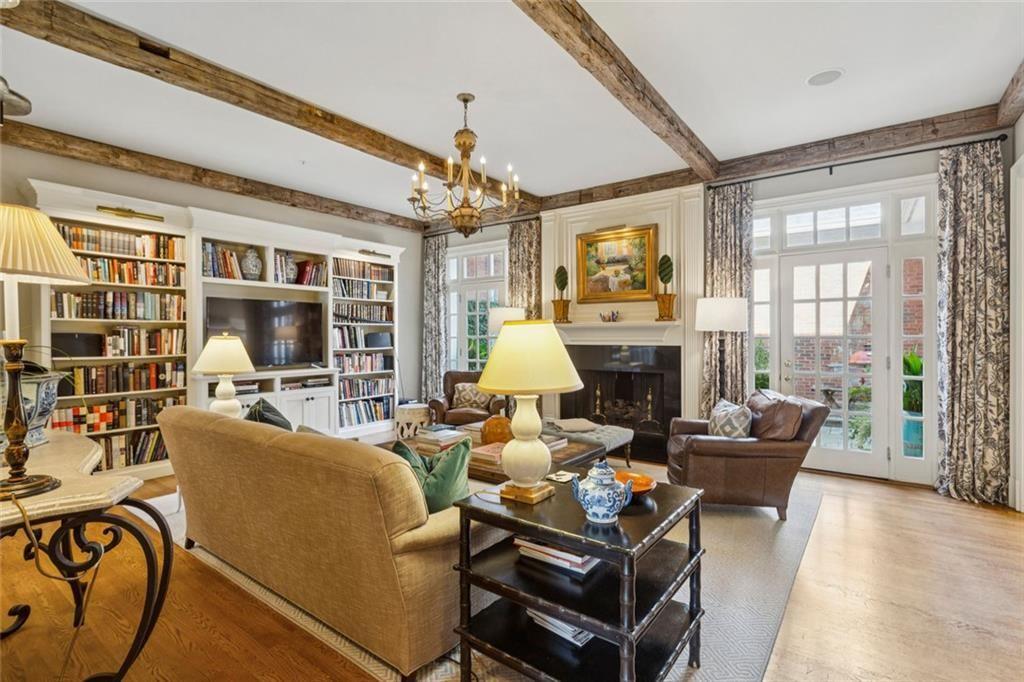 3005 Ranch Road Southeast Atlanta, GA 30339 - Photo 18 of 57 a living room with furniture a chandelier and a fireplace