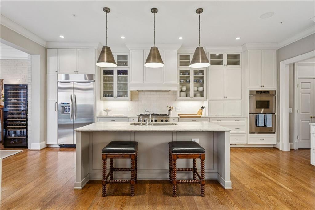 3005 Ranch Road Southeast Atlanta, GA 30339 - Photo 20 of 57 a kitchen with kitchen island a stove a table and chairs in it