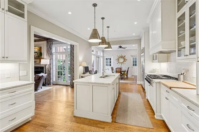 a kitchen with stainless steel appliances granite countertop a sink stove and cabinets