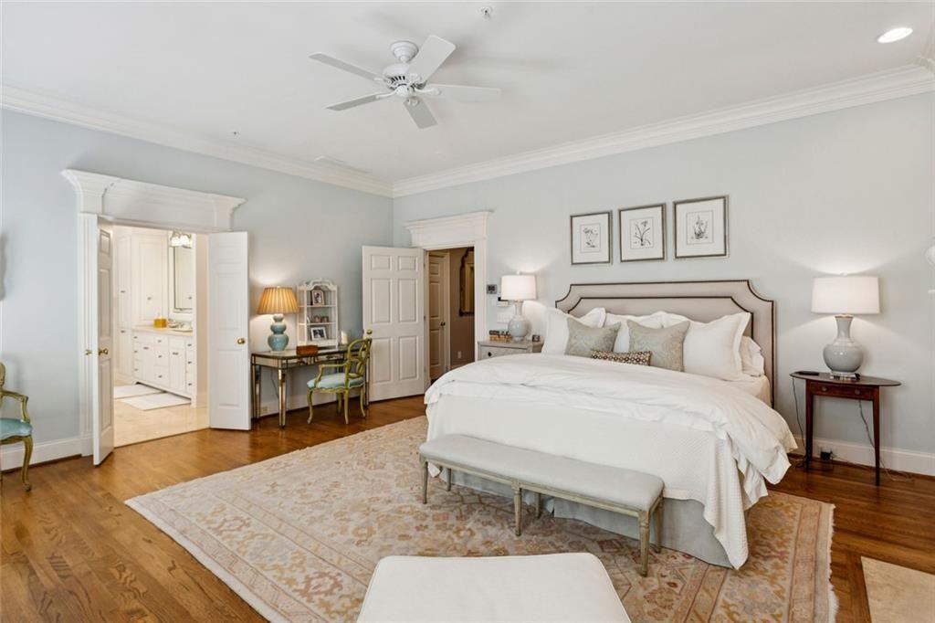 3005 Ranch Road Southeast Atlanta, GA 30339 - Photo 36 of 57 a spacious bedroom with a bed a table and wooden floor