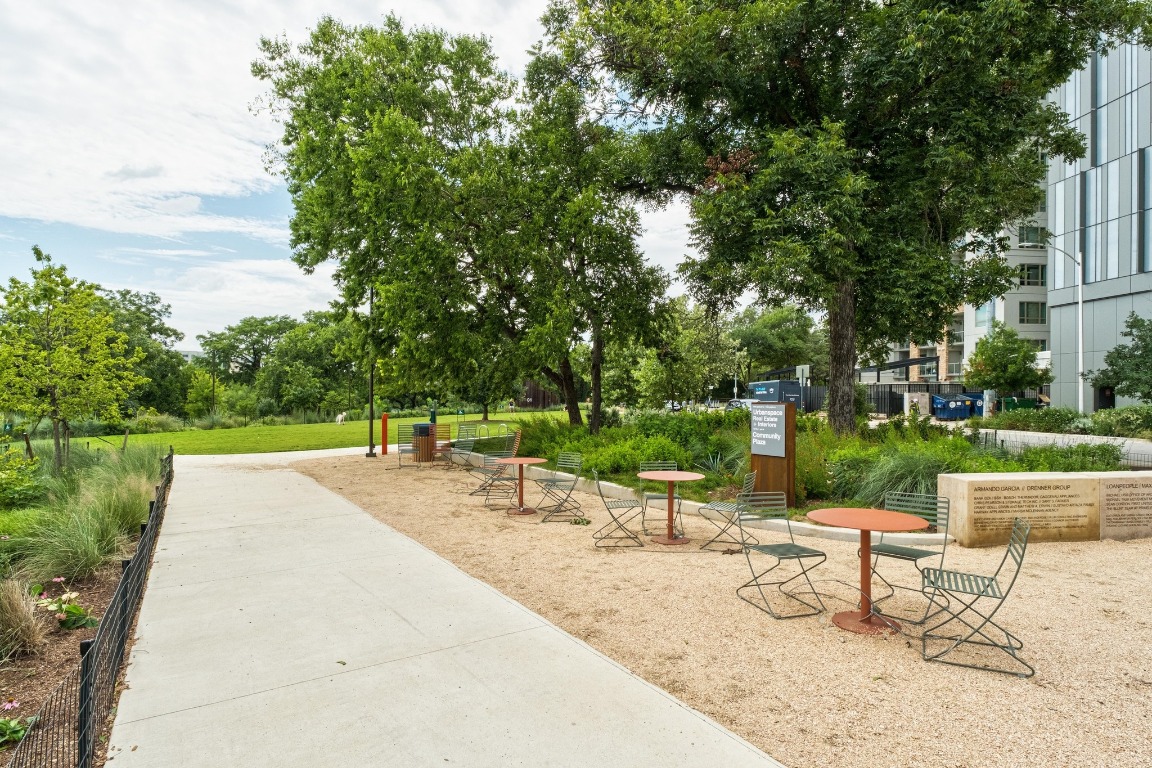 54 Rainey Street, Unit 1018 Austin, TX 78701 - Photo 27 of 33 a view of a park with couches and wooden fence