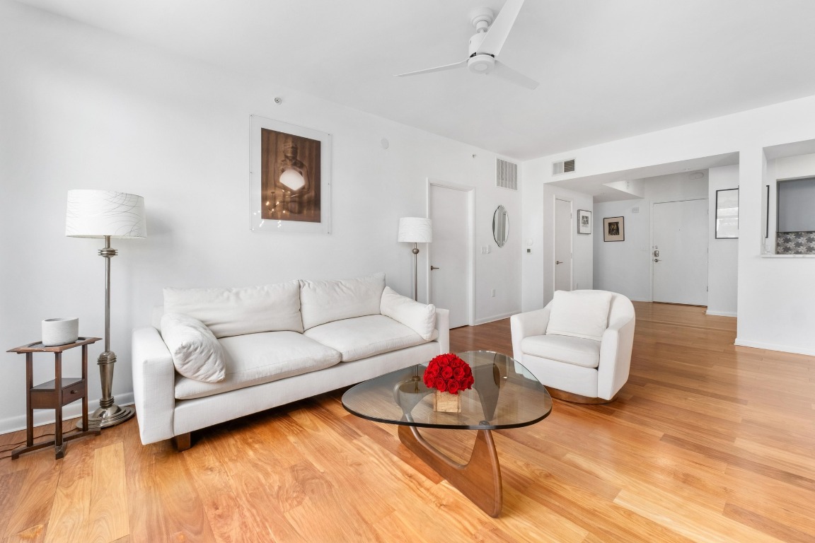 54 Rainey Street, Unit 1018 Austin, TX 78701 - Photo 4 of 33 a living room with furniture and a wooden floor