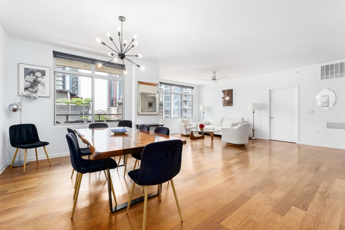 54 Rainey Street, Unit 1018 Austin, TX 78701 - Photo 6 of 33 a living room with furniture and a chandelier