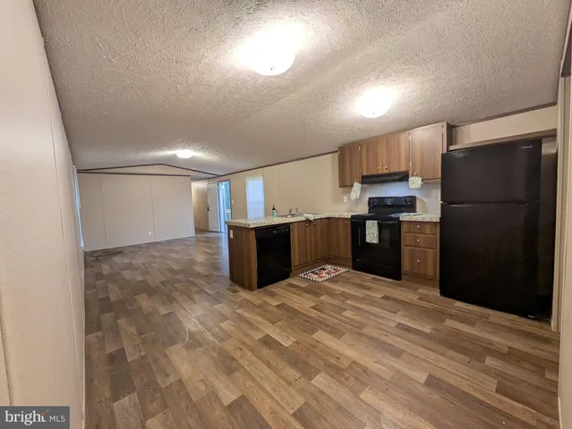 a large kitchen with a refrigerator and a sink