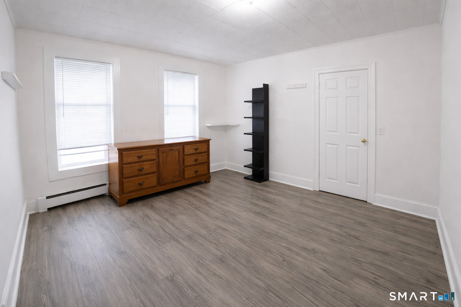 687 Hallett Street, Unit 1 Bridgeport, CT 06608 - Photo 4 of 5 a view of an empty room with a window and wooden floor