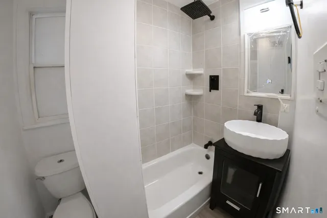 a bathroom with a sink toilet and shower