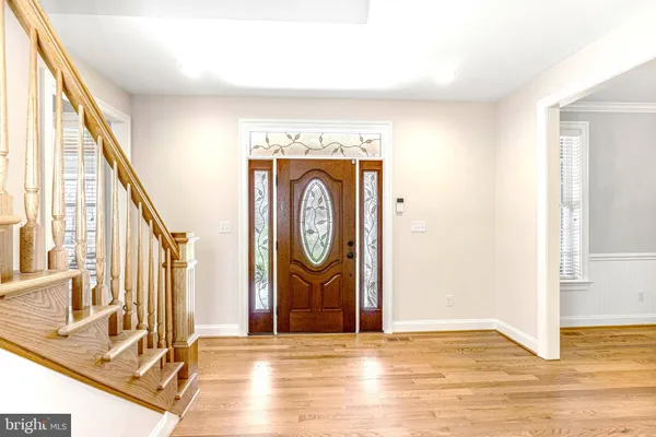 a large kitchen with granite countertop a large window a sink and cabinets