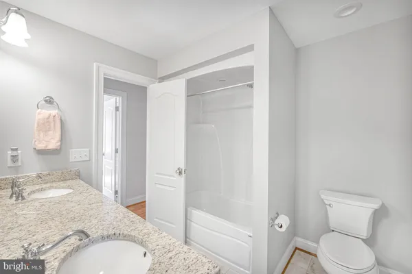 a backyard of a house with a yard and outdoor seating