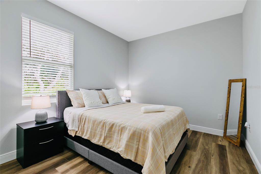 189 Statler Street Port Charlotte, FL 33954 - Photo 20 of 32 a bedroom with a bed and a flat tv screen on a dresser