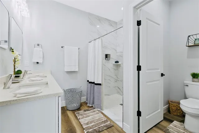 a bathroom with a sink toilet and shower