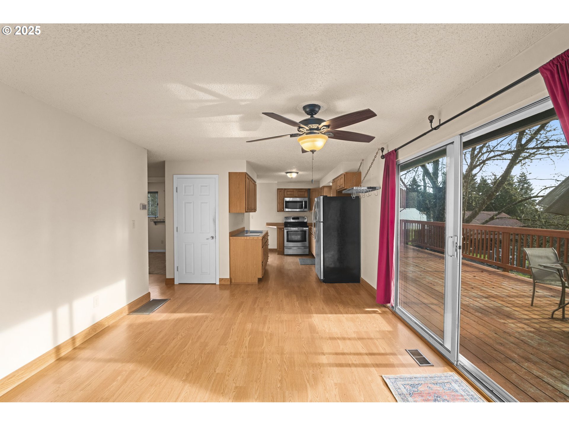 32198 Cater Road Warren, OR 97053 - Photo 21 of 48 a open kitchen with stainless steel appliances kitchen island granite countertop a refrigerator and a wooden floor