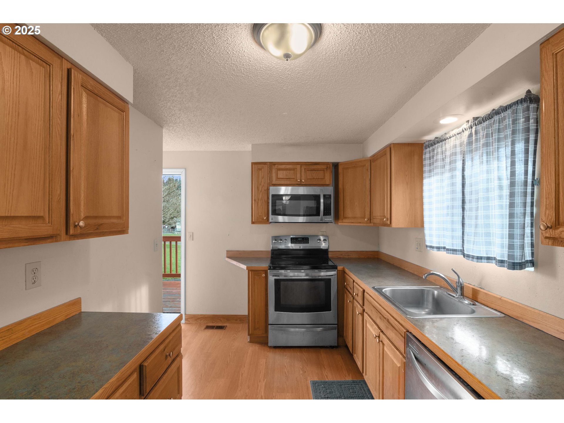 32198 Cater Road Warren, OR 97053 - Photo 27 of 48 a kitchen with stainless steel appliances granite countertop a sink stove and microwave