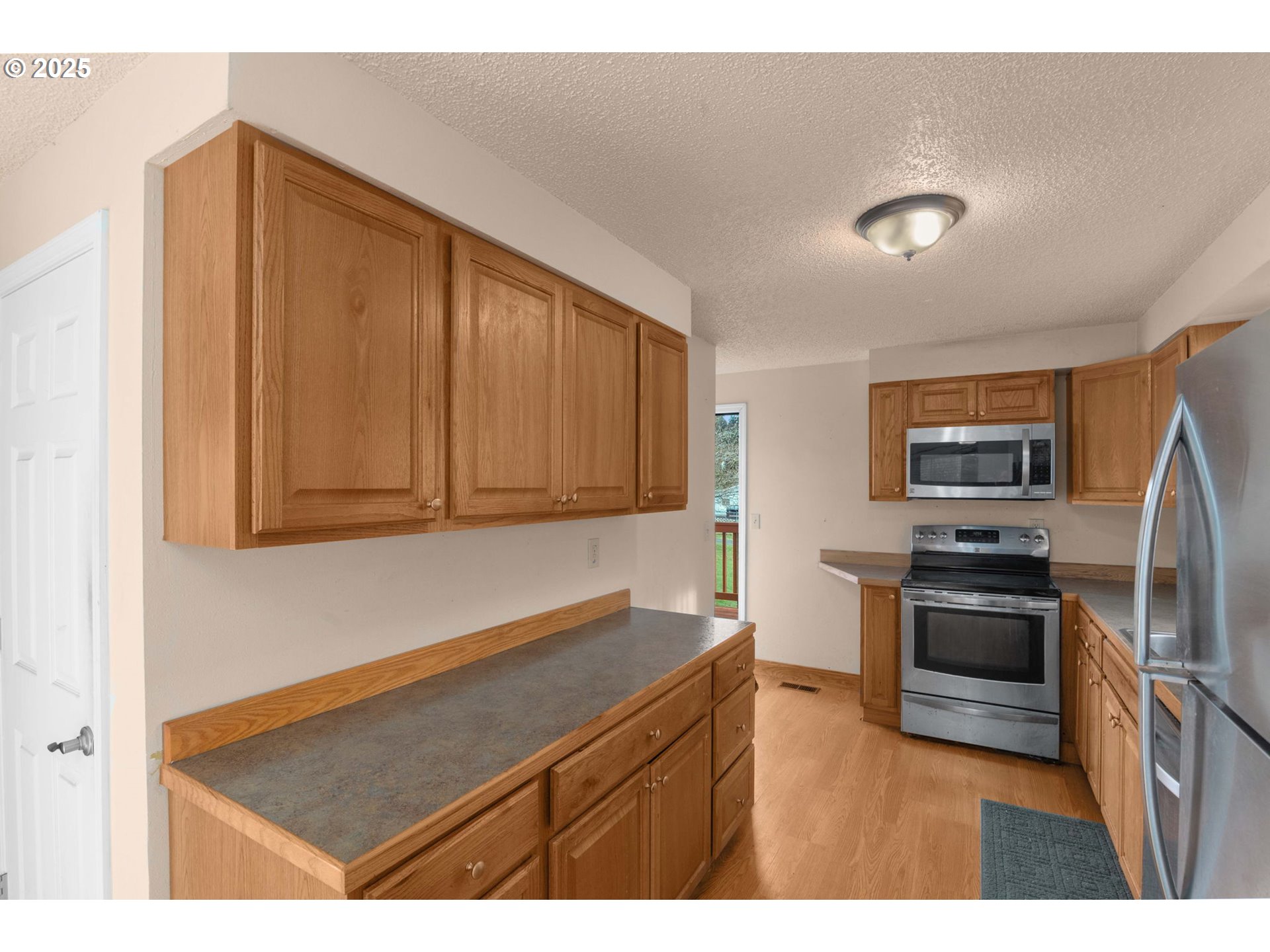 32198 Cater Road Warren, OR 97053 - Photo 28 of 48 a kitchen with stainless steel appliances kitchen island granite countertop a refrigerator stove and sink