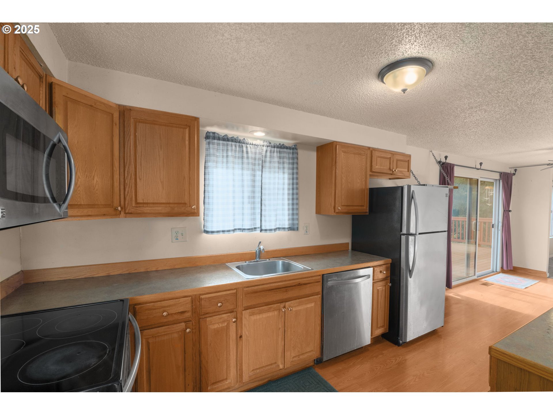 32198 Cater Road Warren, OR 97053 - Photo 30 of 48 a kitchen with a sink a refrigerator and cabinets