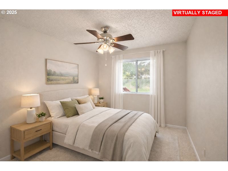 32198 Cater Road Warren, OR 97053 - Photo 7 of 48 a bedroom with a bed and a chandelier