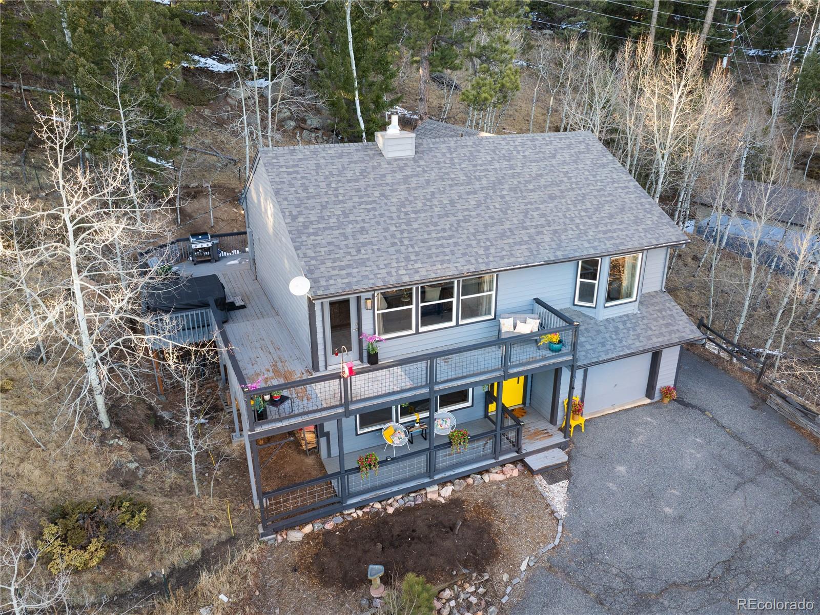 11740 Baca Road Conifer, CO 80433 - Photo 47 of 49 a view of house with a yard and sitting area
