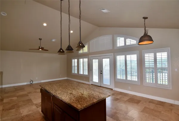 a kitchen with stainless steel appliances granite countertop a sink a refrigerator and a stove