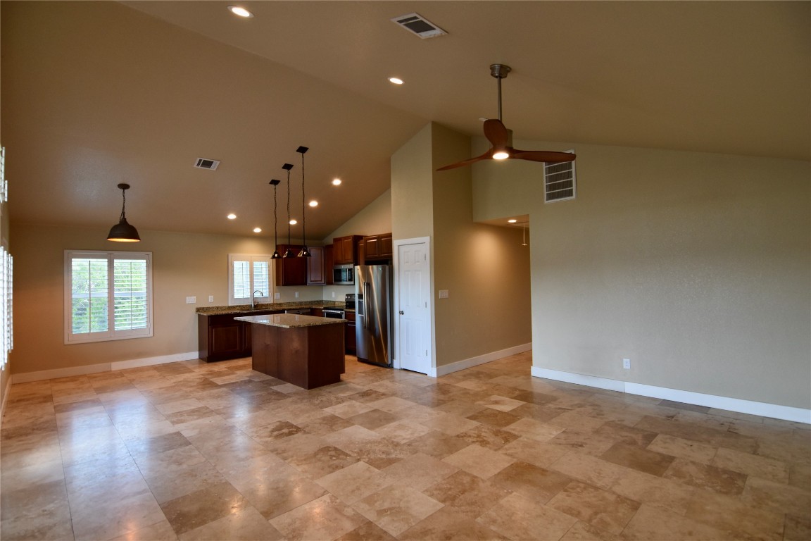 112 Ridge Harbor Drive Spicewood, TX 78669 - Photo 14 of 40 a kitchen with stainless steel appliances granite countertop a sink a refrigerator and a stove