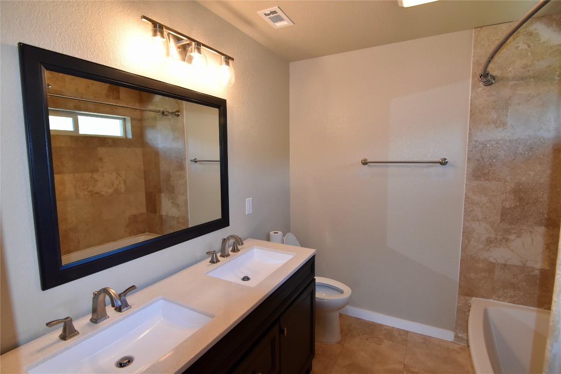 112 Ridge Harbor Drive Spicewood, TX 78669 - Photo 17 of 40 a bathroom with a sink and a mirror