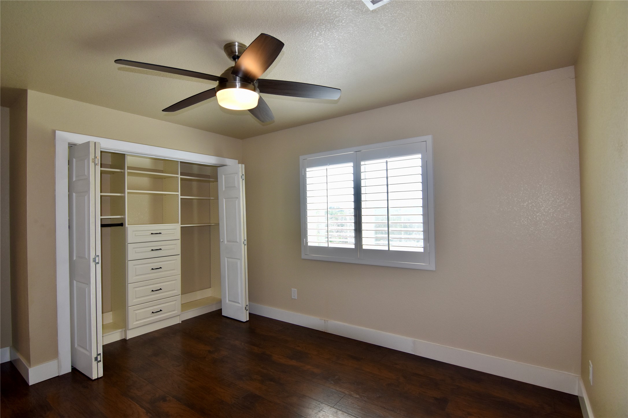 112 Ridge Harbor Drive Spicewood, TX 78669 - Photo 18 of 40 a view of an empty room with a window and wooden floor