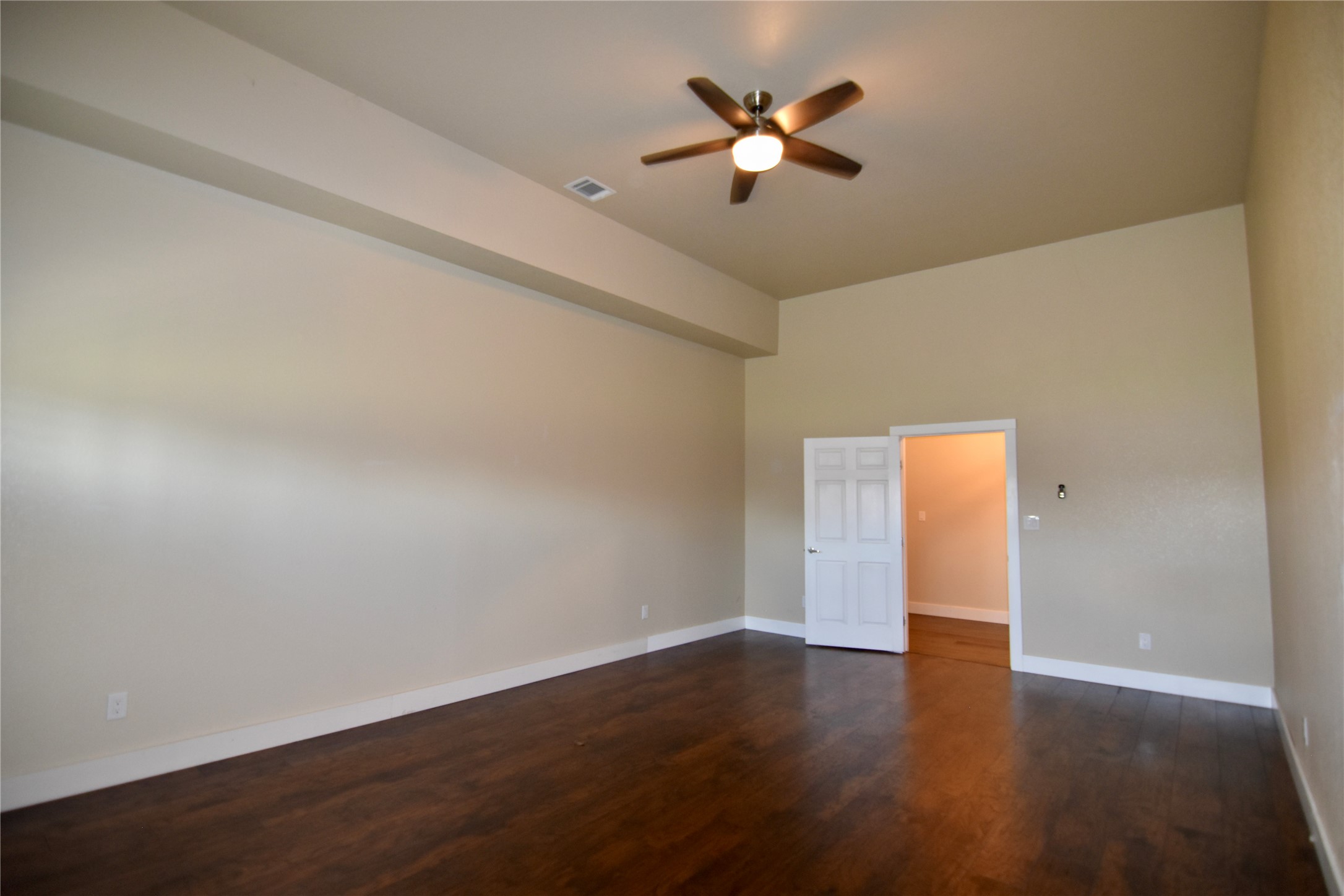 112 Ridge Harbor Drive Spicewood, TX 78669 - Photo 22 of 40 a view of an empty room with wooden floor and a ceiling fan