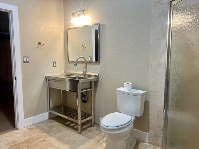 a bathroom with a sink toilet and mirror
