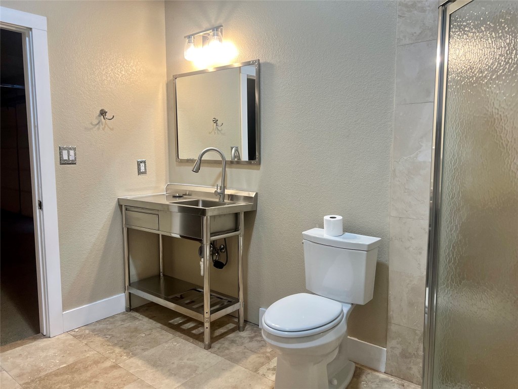 112 Ridge Harbor Drive Spicewood, TX 78669 - Photo 23 of 40 a bathroom with a sink toilet and mirror