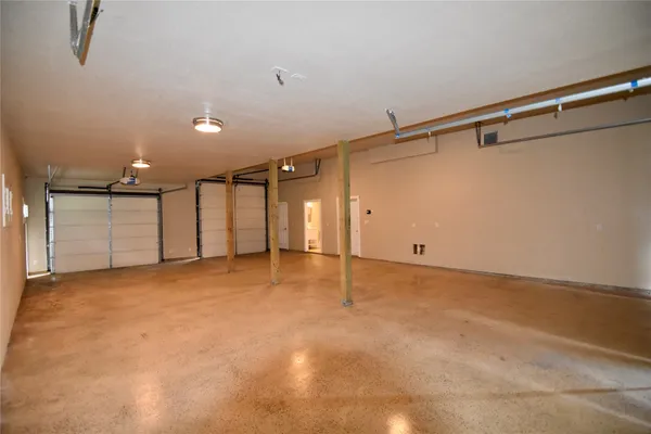 an empty room with fan and windows
