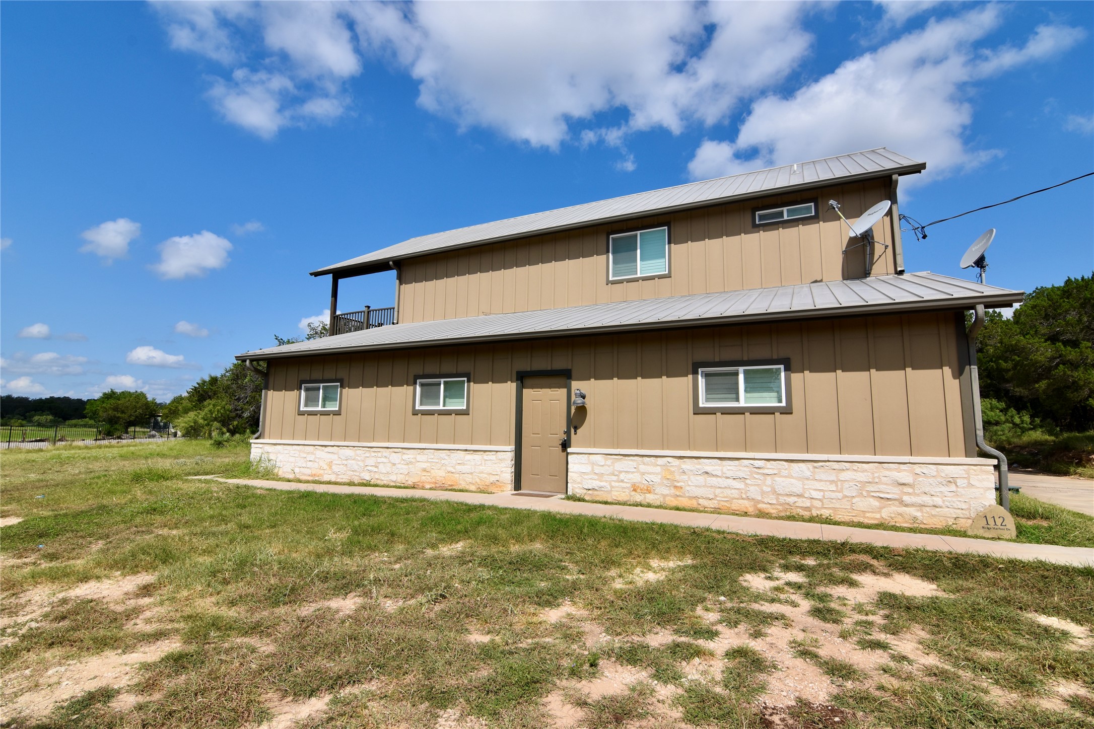 112 Ridge Harbor Drive Spicewood, TX 78669 - Photo 37 of 40 a house with a yard in front of it