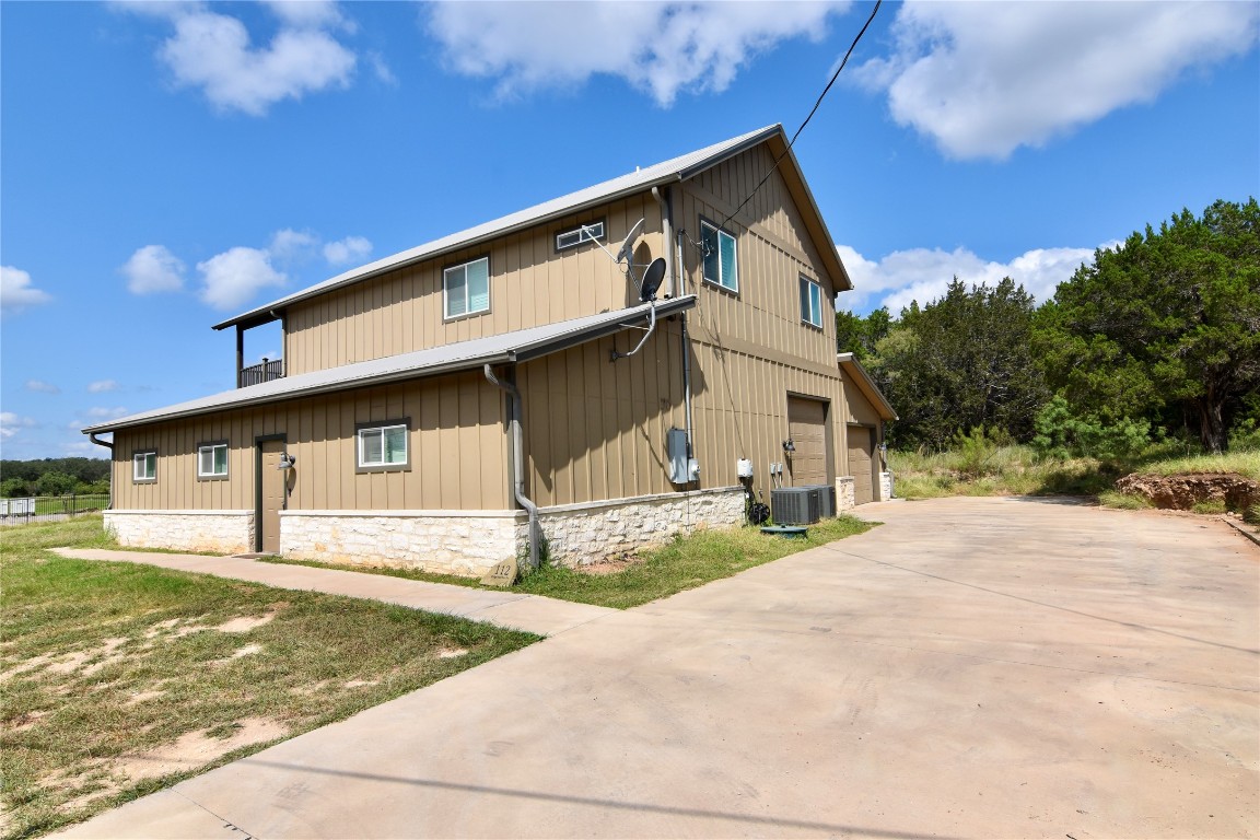 112 Ridge Harbor Drive Spicewood, TX 78669 - Photo 4 of 40 a front view of a house with garage