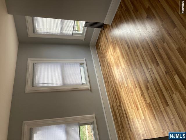 129 Union Street Hackensack, NJ 07601 - Photo 3 of 10 a view of empty room with wooden floor and fan