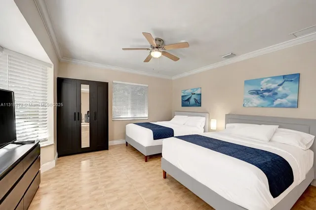 a spacious bedroom with two beds and a couch