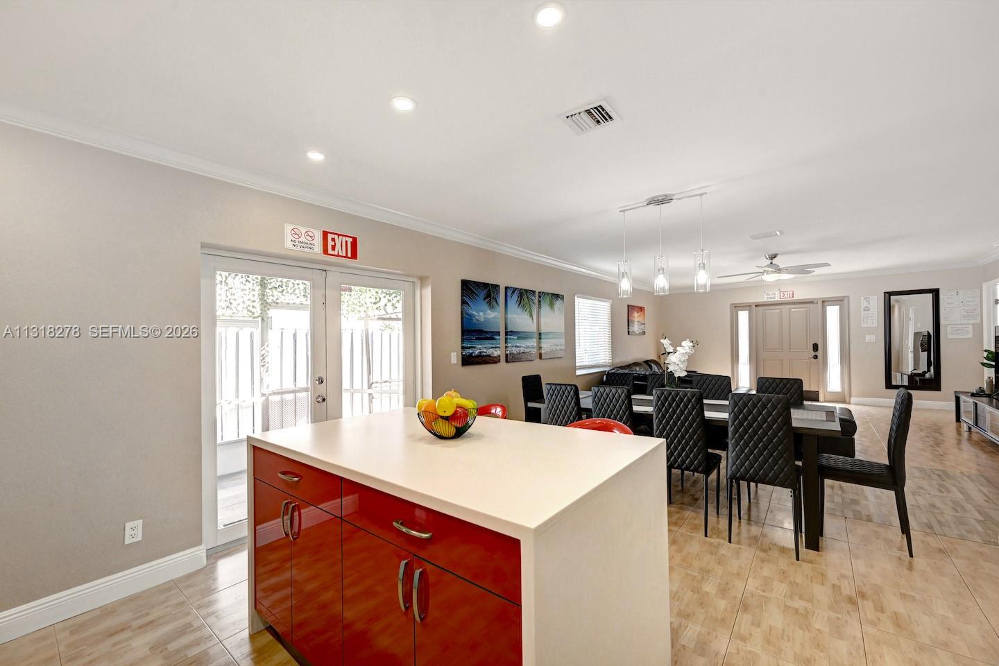 825 Harrison Street Hollywood, FL 33019 - Photo 12 of 37 a view of a dining room with furniture and chandelier