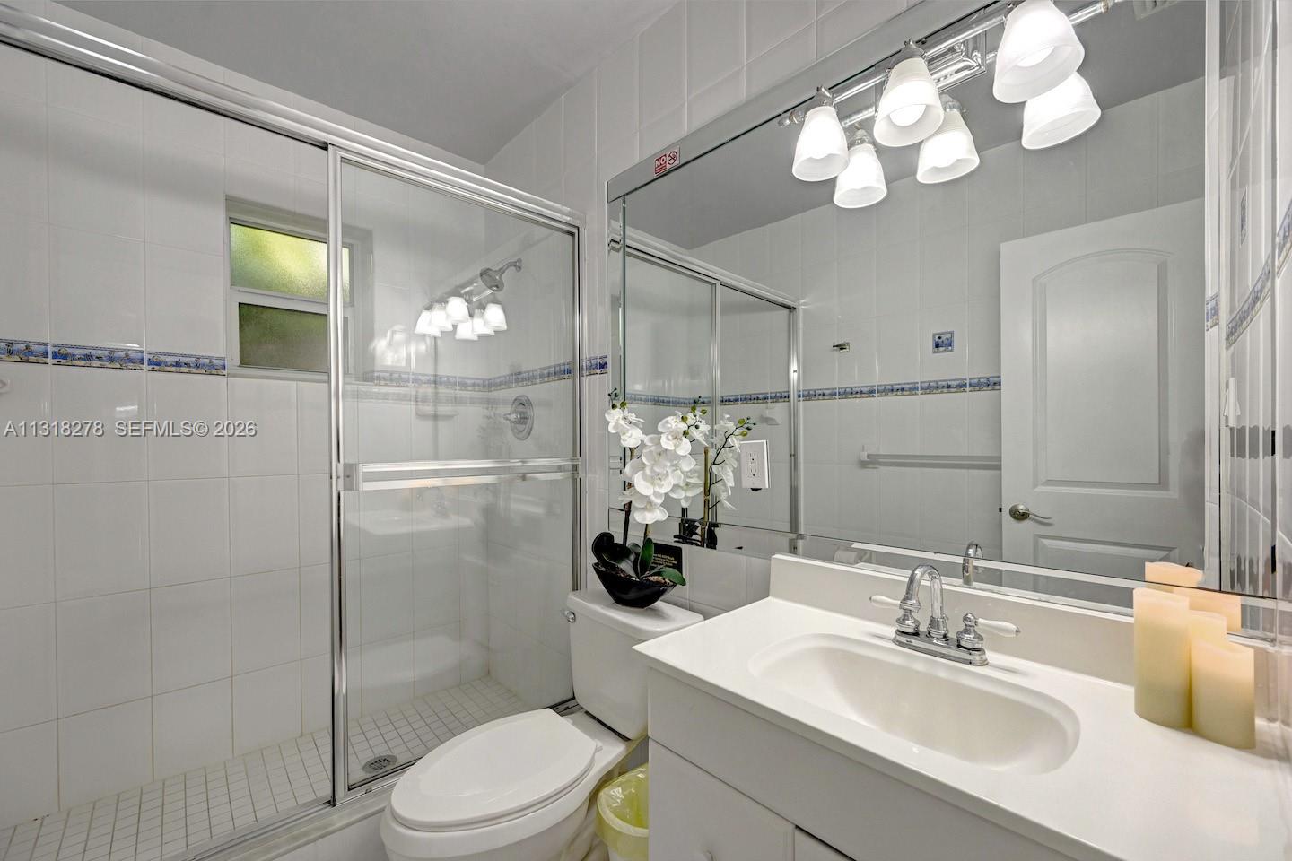 825 Harrison Street Hollywood, FL 33019 - Photo 15 of 37 a bathroom with a sink vanity granite toilet and shower