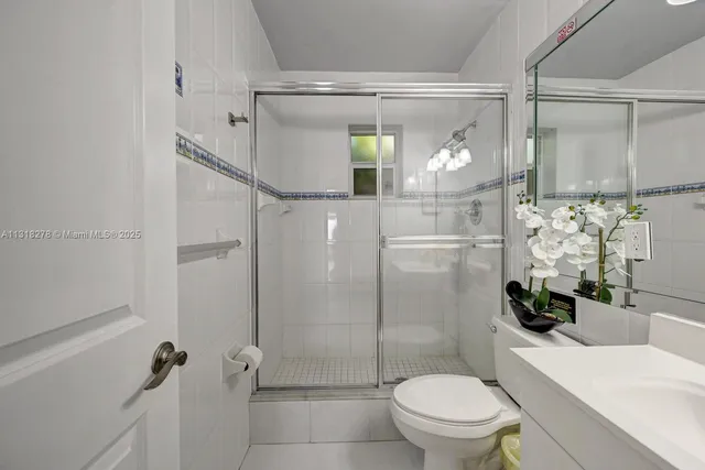 a bathroom with a shower a toilet and a sink