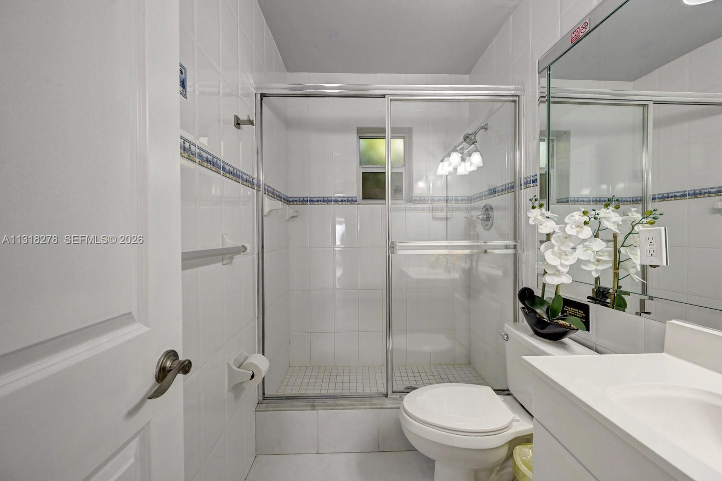825 Harrison Street Hollywood, FL 33019 - Photo 16 of 37 a bathroom with a shower a toilet and a sink