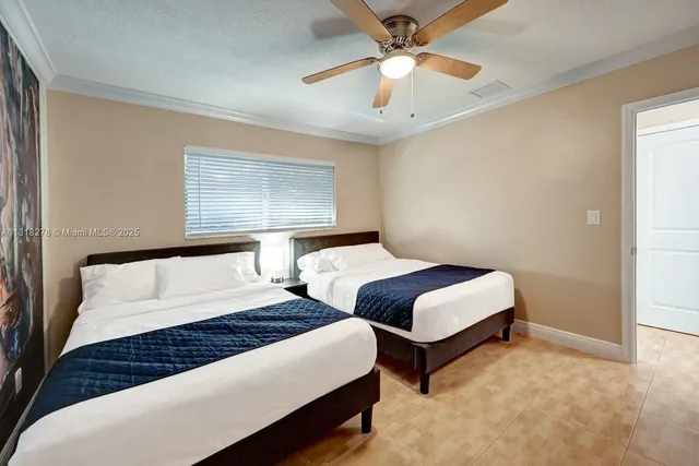 a bedroom with bed and a chandelier
