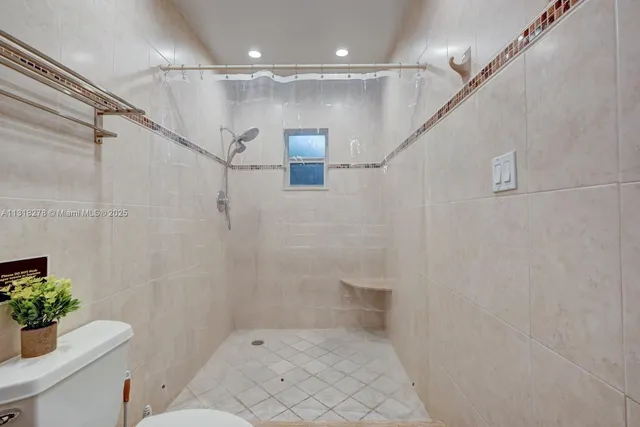 a bathroom with a shower and a toilet