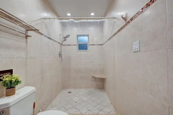 a bathroom with a shower and a toilet