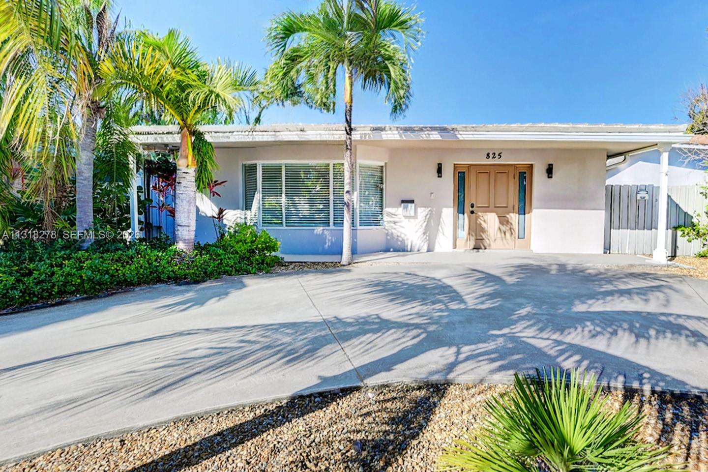 825 Harrison Street Hollywood, FL 33019 - Photo 2 of 37 front view of a house with a yard