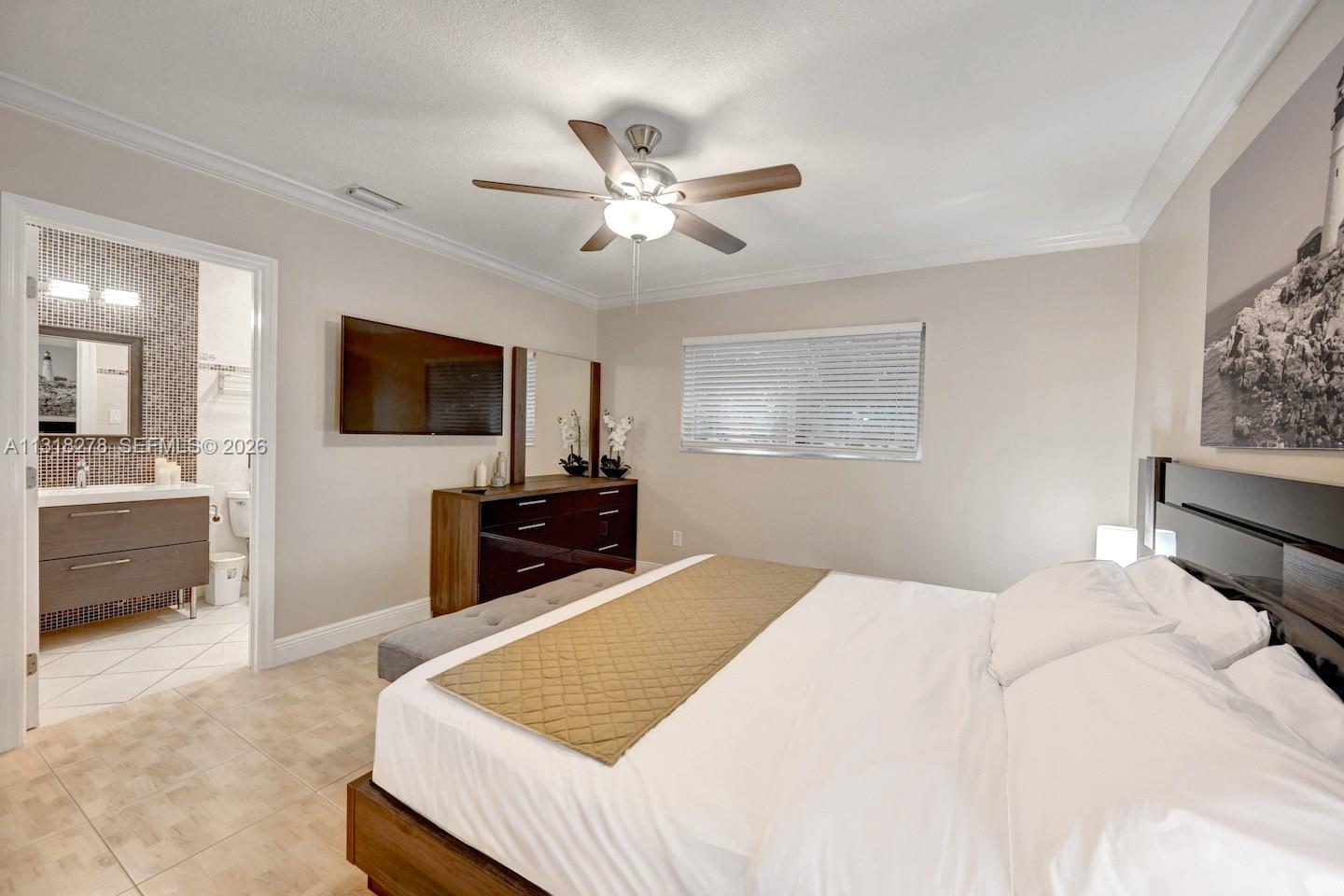 825 Harrison Street Hollywood, FL 33019 - Photo 22 of 37 a bedroom with a bed and a flat screen tv