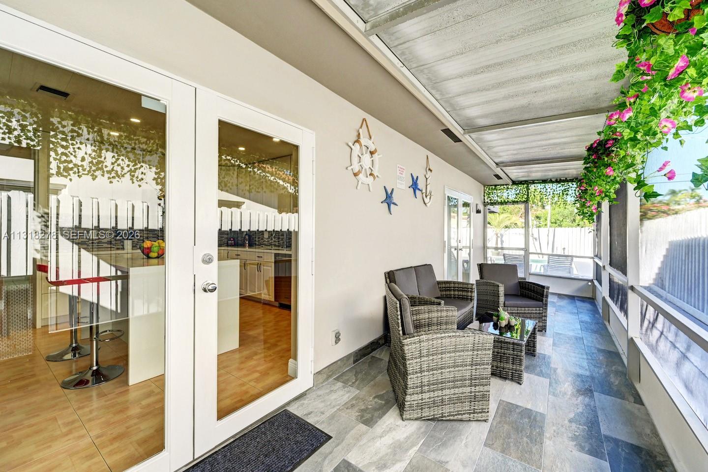 825 Harrison Street Hollywood, FL 33019 - Photo 26 of 37 a living room with furniture and a potted plant