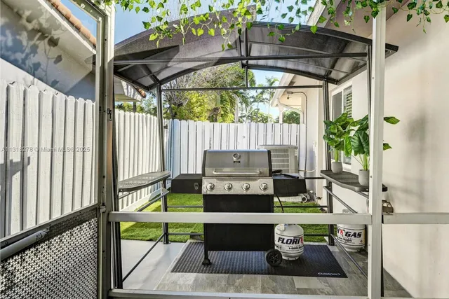a view of balcony with two chairs and a potted plant