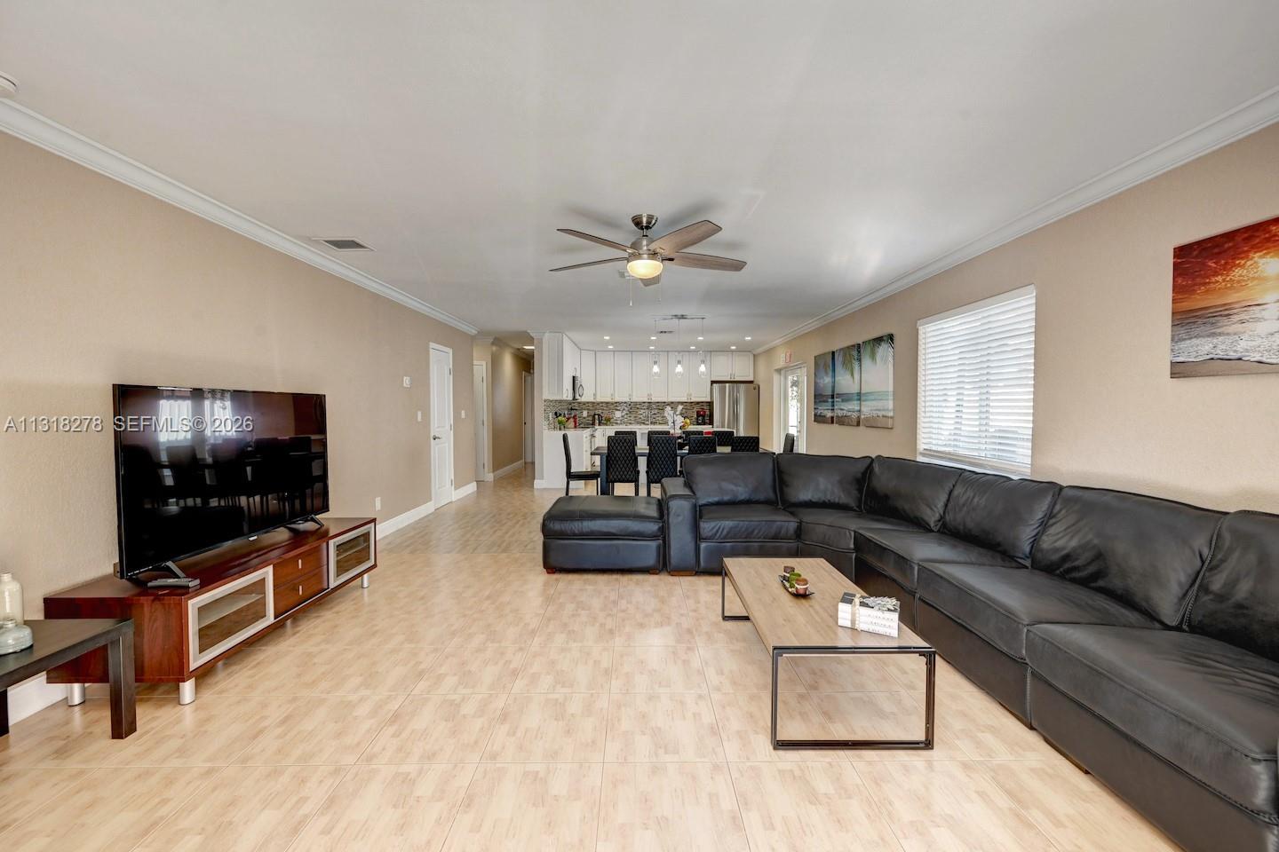 825 Harrison Street Hollywood, FL 33019 - Photo 4 of 37 a living room with furniture and a flat screen tv