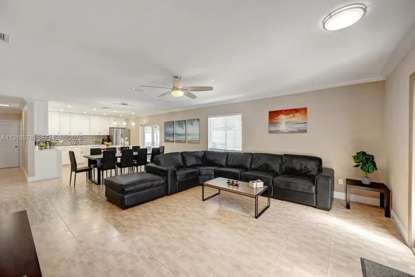 a living room with furniture and kitchen view