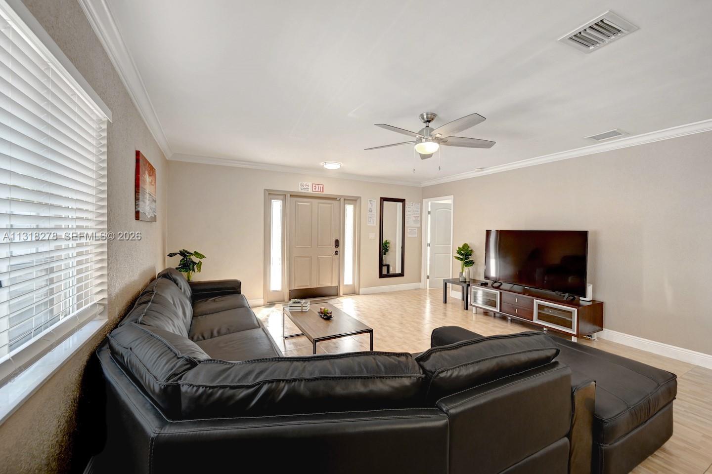 825 Harrison Street Hollywood, FL 33019 - Photo 7 of 37 a living room with furniture and a flat screen tv