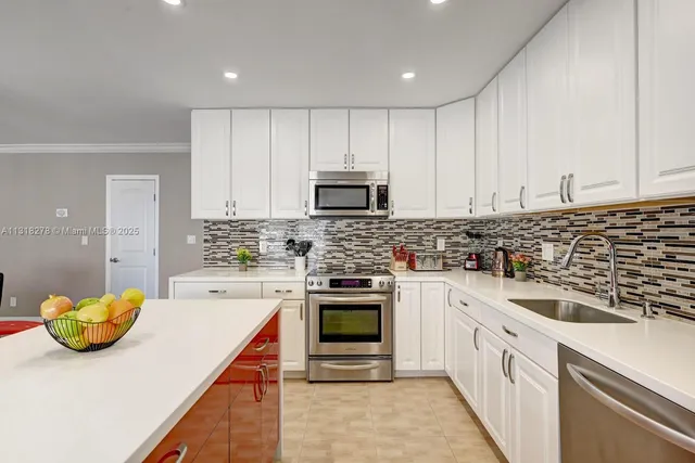 a kitchen with a sink cabinets and stainless steel appliances