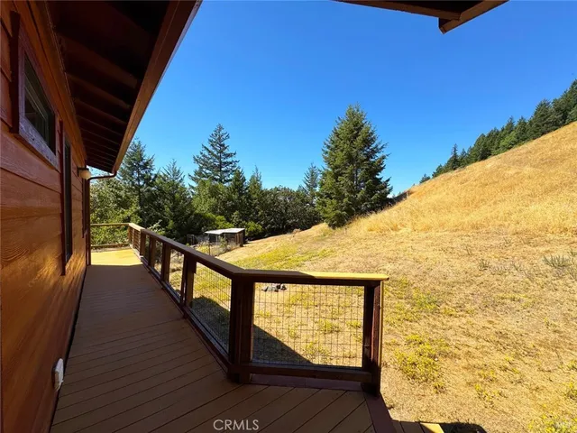 a view of balcony with wooden floor and fence