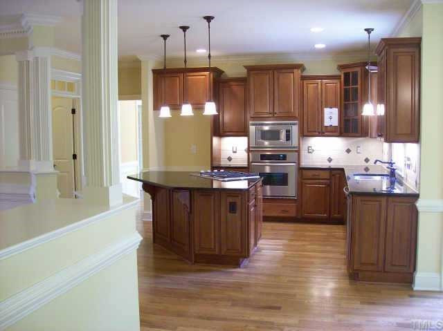3928 Bending Birch Drive Raleigh, NC 27613 - Photo 5 of 10 coming in from the garage/mudroom, looking past the nook area into the kitchen. Kitchen has granite tops, under cabinets lights and access to screen porch Other